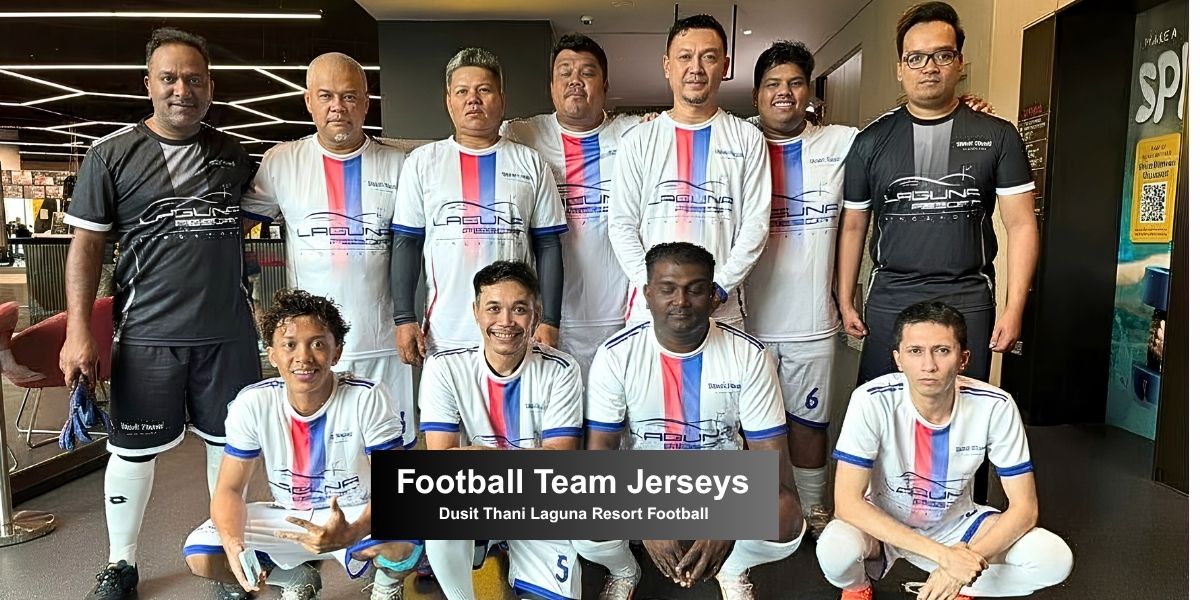 Football players from Dusit Thani posing together in custom made white jerseys with red and blue vertical stripes made by LEAM.