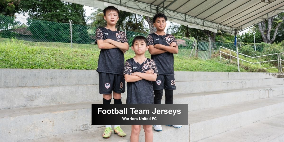 Three youth football players from Warriors United FC wearing custom football team jerseys and shorts made by LEAM.